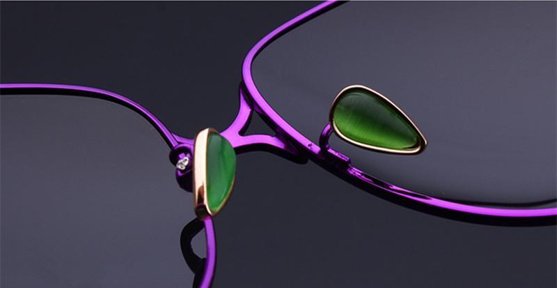 Stevvex purple sunglasses green stone nose pad detail on dark background