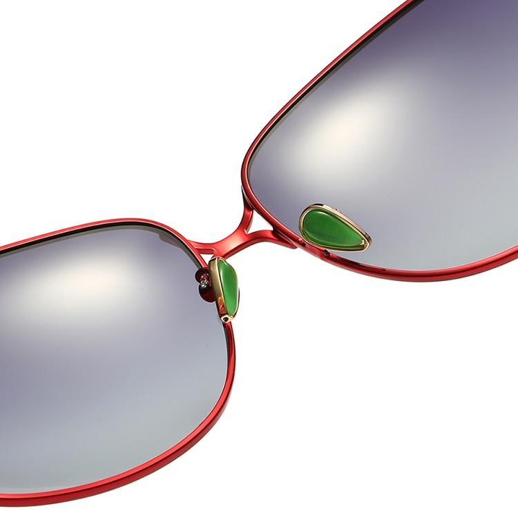 Stevvex sunglasses close-up of red frame and green gemstone nose pads