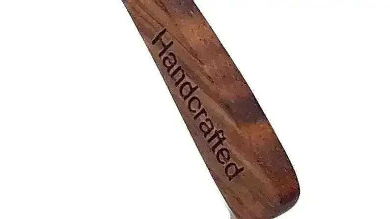Close-up of handcrafted artisan engraved wooden temple arm